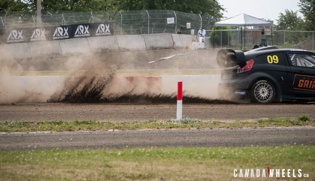 A matte black ARX2 car kicking dirt